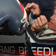 Former land speed record holder Craig Breedlove reaches for his helmet prior to making his first test run in his car “Spirit of America” Wednesday, Oct 23, 1996, in the Black Rock Desert near Gerlach Nev. (AP Photo/Rich Pedroncelli)